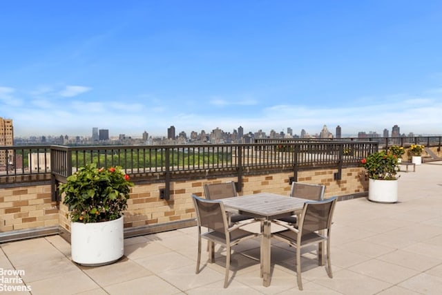 view of patio with a view of city and outdoor dining area