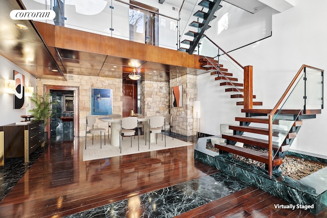 interior space with a high ceiling and hardwood / wood-style floors