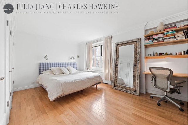 bedroom with crown molding and light hardwood / wood-style flooring