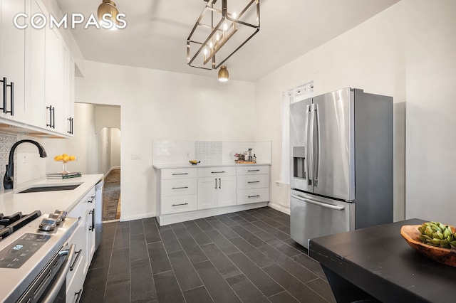 kitchen featuring stainless steel fridge with ice dispenser, a sink, light countertops, white cabinetry, and backsplash