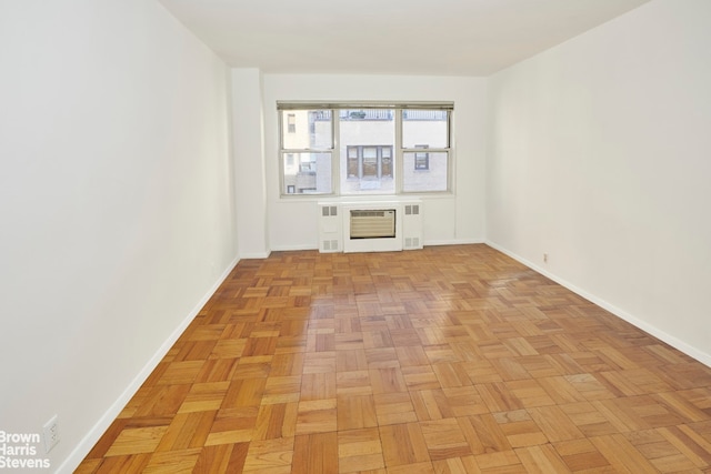 unfurnished room with light parquet flooring and heating unit