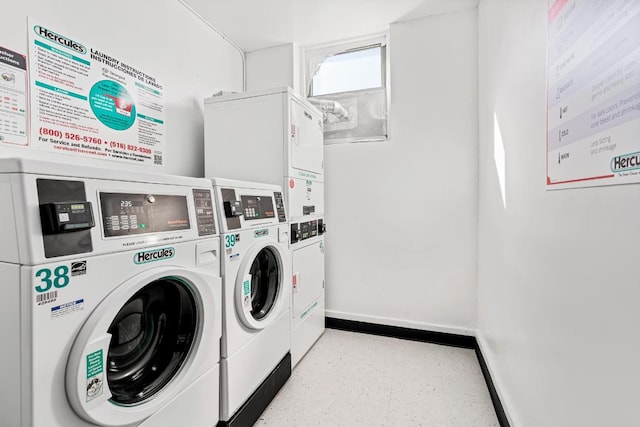 shared laundry area featuring stacked washer and clothes dryer, baseboards, and washing machine and clothes dryer