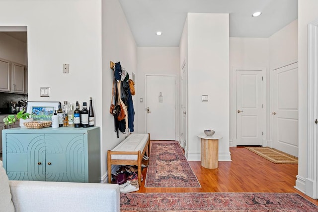 interior space with baseboards, wood finished floors, and recessed lighting