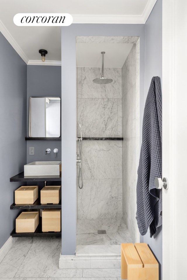 333 E 53rd St Unit 11A, New York City, NY 10022 - bathroom featuring marble look tile flooring, a marble finish shower, vanity, ornamental molding, and baseboards