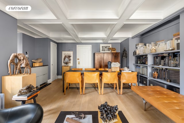 dining space with coffered ceiling, beam ceiling, and light hardwood / wood-style flooring