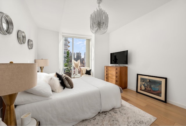 bedroom with baseboards and light wood finished floors