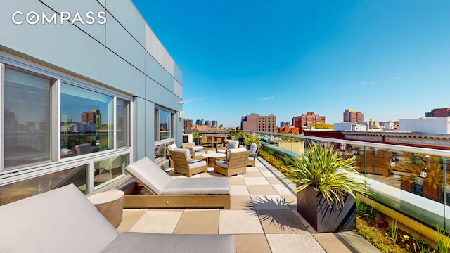 balcony with a city view and an outdoor living space