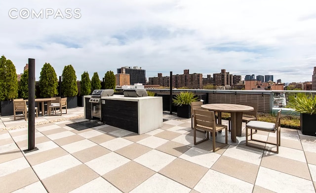 171 W 131st St Unit 620, New York City, NY 10027 - view of patio with outdoor dining space, a skyline view, and an outdoor kitchen