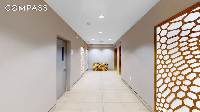 hallway featuring light tile patterned floors and recessed lighting