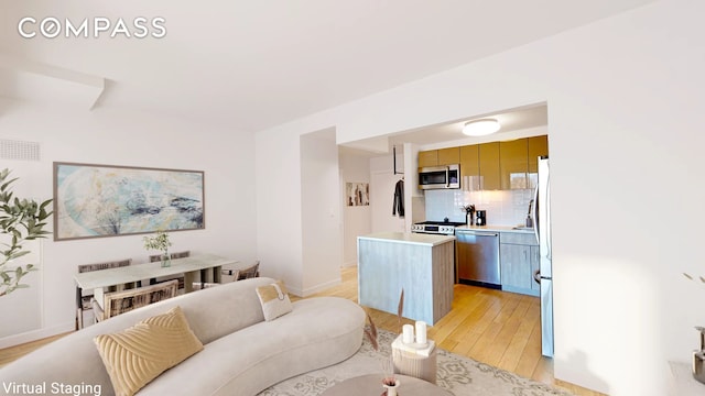 living room featuring light wood-type flooring and baseboards