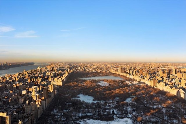 aerial view at dusk featuring a water view