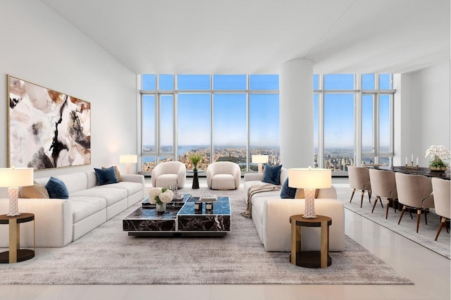 living room with tile patterned floors and a wall of windows