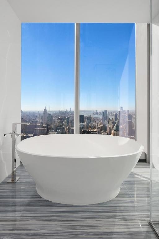 bathroom with plenty of natural light and a bathtub