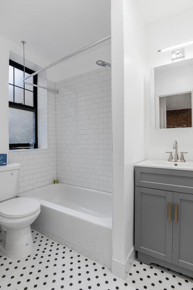 full bathroom featuring washtub / shower combination, vanity, toilet, and tile patterned floors