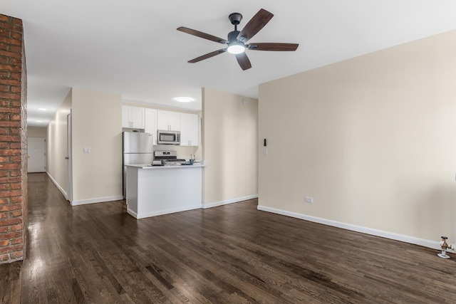 unfurnished living room featuring a ceiling fan, baseboards, and dark wood-type flooring