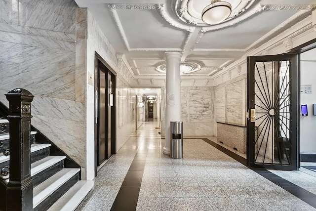 hall with coffered ceiling, elevator, ornamental molding, ornate columns, and granite finish floor