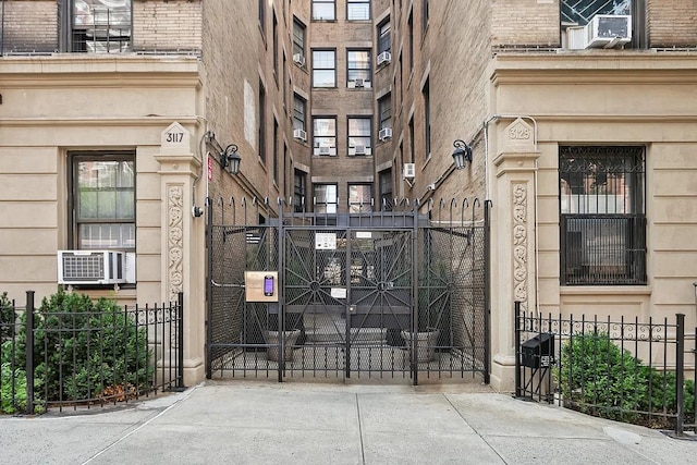 view of gate featuring cooling unit and fence