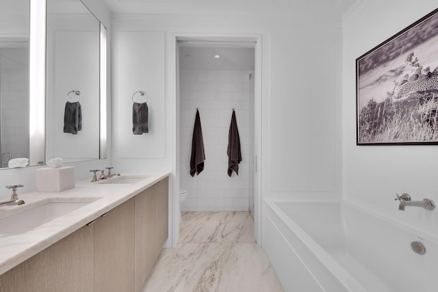bathroom featuring a sink, a bathing tub, toilet, and double vanity