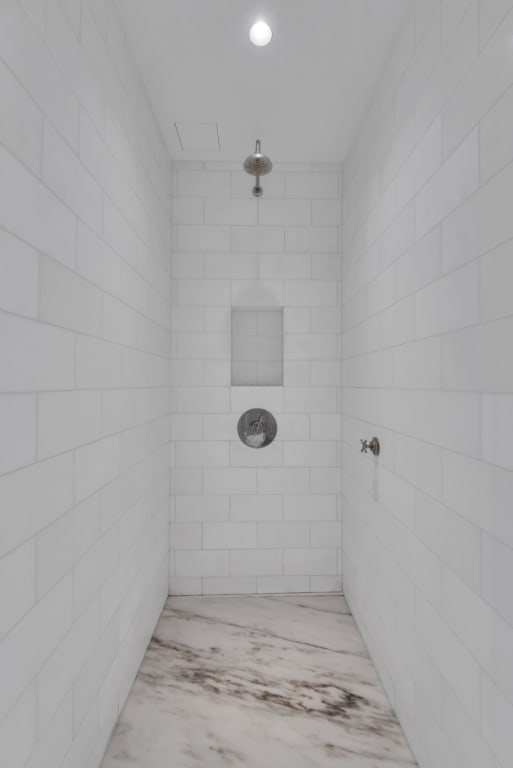 bathroom with a tile shower