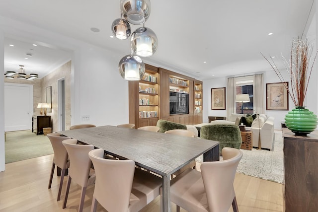 dining room featuring recessed lighting, a notable chandelier, and light wood-style flooring