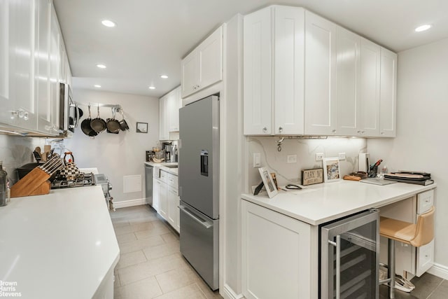 25 Sutton Pl S Unit 20J, New York City, NY 10022 - kitchen featuring stainless steel appliances, beverage cooler, recessed lighting, white cabinets, and light countertops