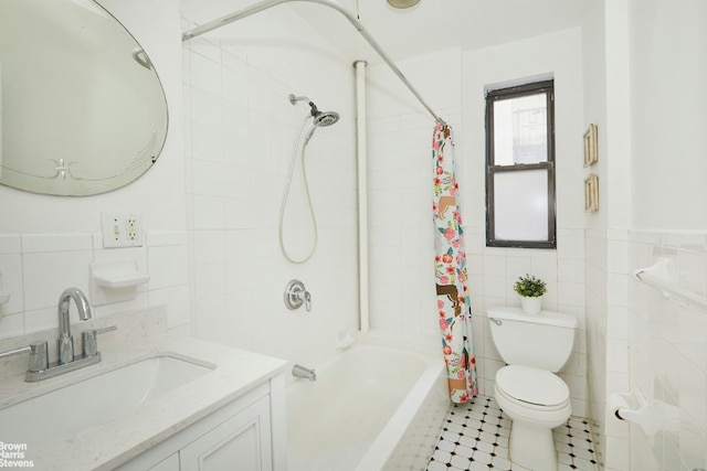 full bathroom with shower / tub combo with curtain, vanity, toilet, and tile walls