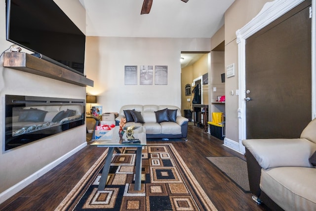 living room with ceiling fan and dark hardwood / wood-style flooring