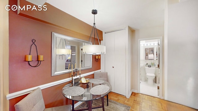 dining room featuring parquet floors