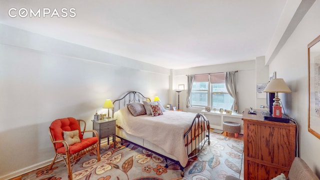 bedroom with wood finished floors and baseboards