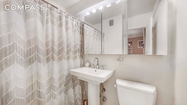 bathroom featuring toilet and sink