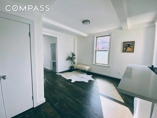 interior space with baseboards and wood finished floors