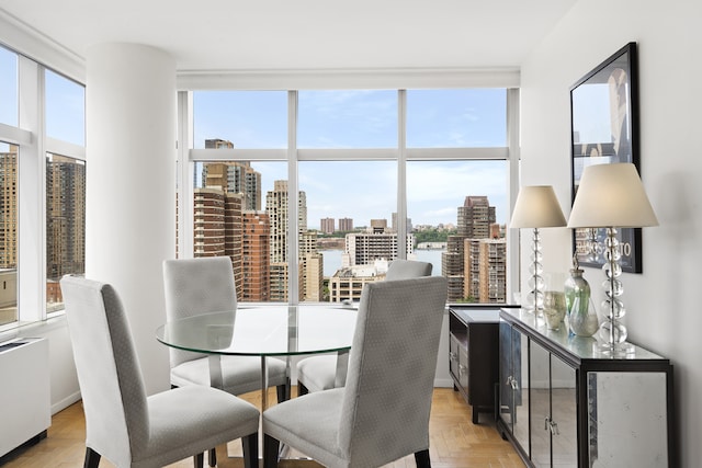 dining area featuring a city view and expansive windows