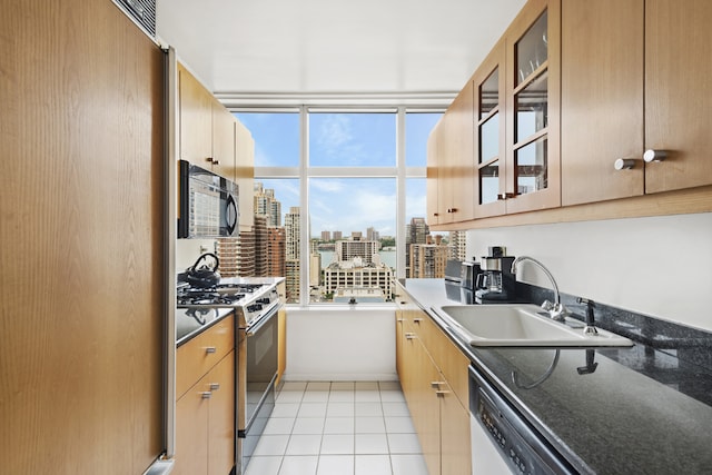 kitchen featuring sink, light tile patterned floors, refrigerator, stainless steel range with gas stovetop, and white dishwasher