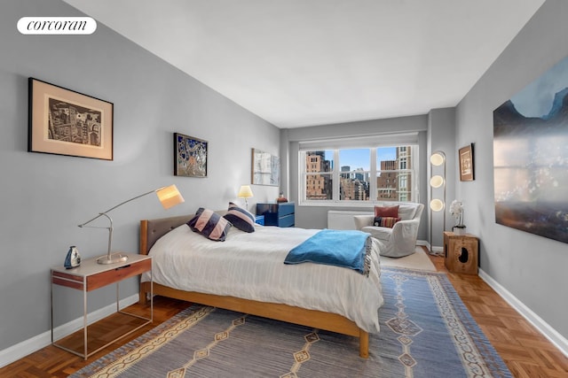 bedroom featuring a city view, visible vents, and baseboards