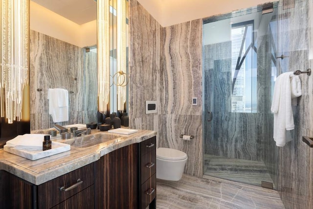 bathroom with a marble finish shower, toilet, tile walls, and vanity