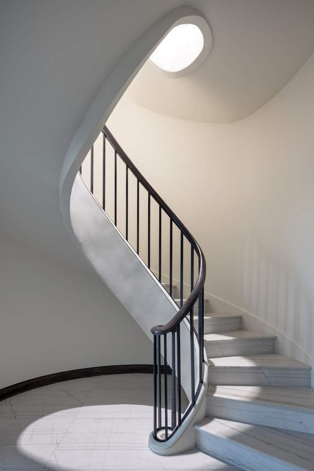 staircase featuring baseboards