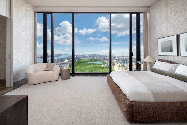 bedroom featuring wood finished floors and wallpapered walls