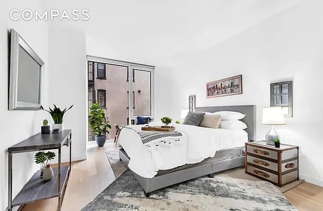 540 W 49th St Unit 406N/407N, New York City, NY 10019 - bedroom with wood finished floors and baseboards