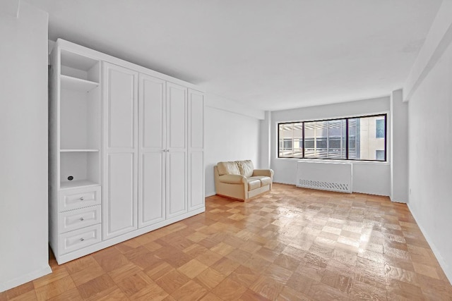 unfurnished room featuring radiator