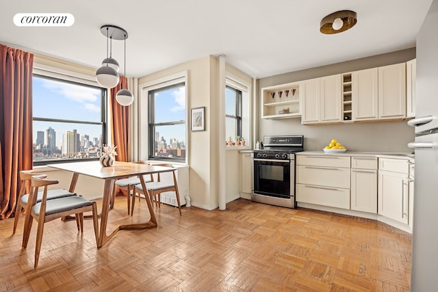 kitchen with pendant lighting, white cabinetry, light parquet floors, and stainless steel gas range oven