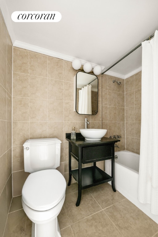 full bathroom featuring sink, tile walls, ornamental molding, shower / bath combo, and tile patterned floors