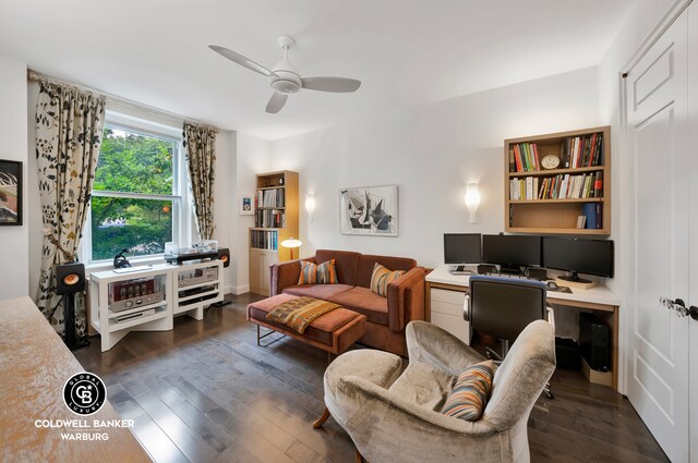 living room featuring dark hardwood / wood-style floors and ceiling fan