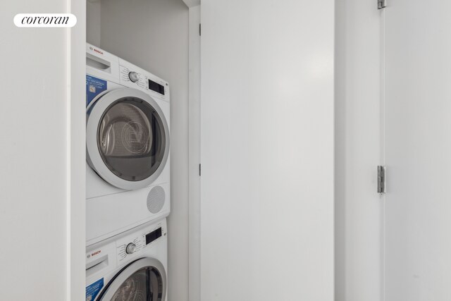 425 Main St Unit 5D, New York City, NY 10044 - clothes washing area with stacked washer and dryer and laundry area
