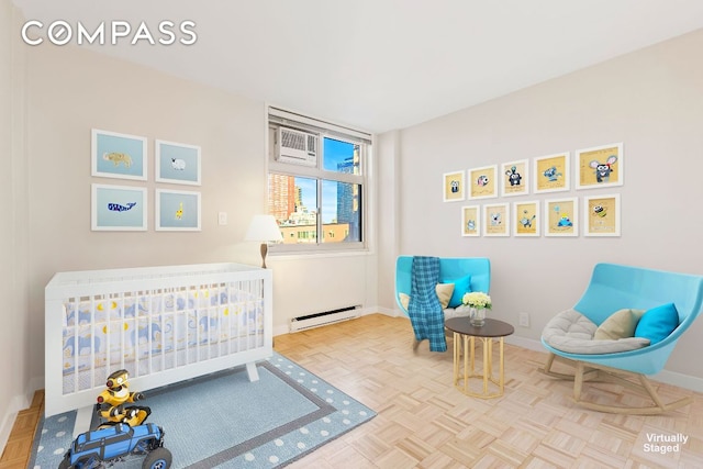 bedroom with baseboard heating, parquet flooring, and a nursery area