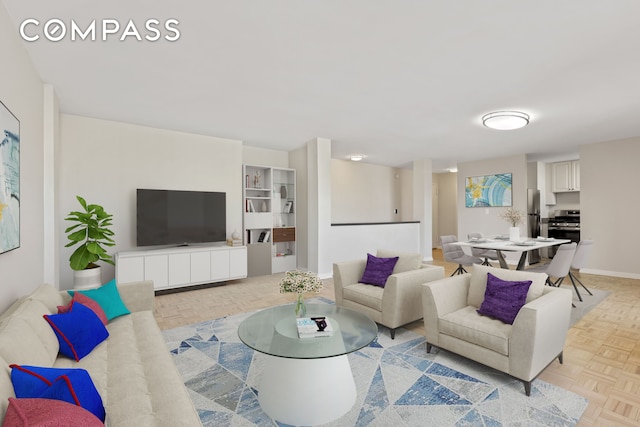 living area featuring baseboards