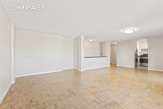 unfurnished living room featuring light parquet flooring