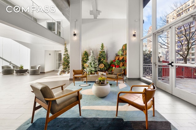 common area featuring a high ceiling and floor to ceiling windows