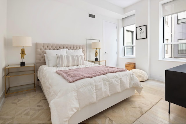 416 W 52nd St Unit Th213, New York City, NY 10019 - bedroom with multiple windows, baseboards, and light wood finished floors