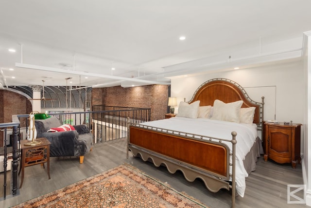 bedroom with recessed lighting and wood finished floors