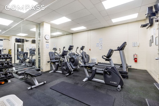 workout area with a paneled ceiling